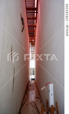 Narrow Maintenance Alleyway Inside Building Under Construction Narrow Maintenance Alleyway Inside Building Under Construction 136183169
