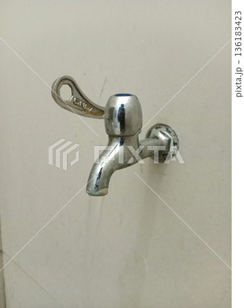 close-up photo of water coming out of a tap close-up photo of water coming out of a tap 136183423