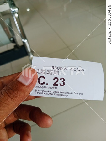 a patient shows proof of queue number at a health center in Yogyakarta, Indonesia on 05-27-2024 a patient shows proof of queue number at a health center in Yogyakarta, Indonesia on 05-27-2024 136183426
