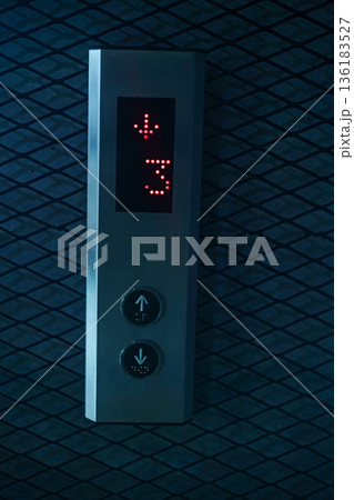 Elevator Up Down Button Panel, A clean photo of elevator up down button panel, buttons with clear labels in sleek metal frame under, for modern building or urban convenience documentary. Elevator Up Down Button Panel, A clean photo of elevator up down button panel, buttons with clear labels in sleek metal frame under, for modern building or urban convenience documentary. 136183527