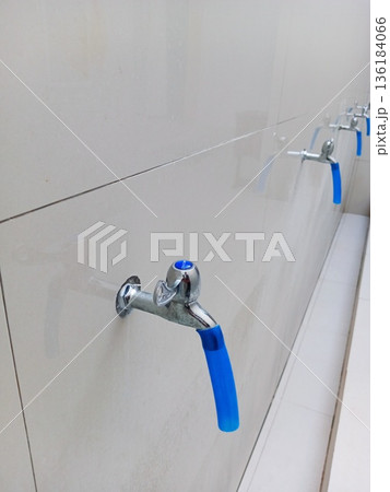 Muslim ablution place with several water taps 136184066