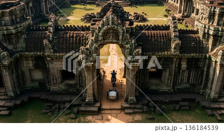Ancient Stone Temple Entrance with Intricate Carvings and Pathway to Sunlight Clearing 136184539