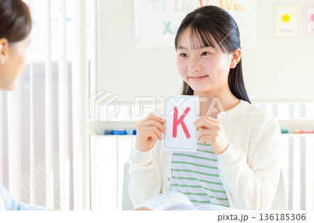 教育　英会話教室でレッスンを受ける子供とネイティブ講師 136185306