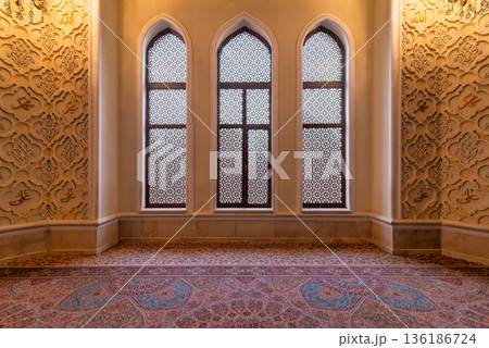 Imamzadeh Mosque interior in Ganja Azerbaijan with ornate windows, Islamic calligraphy, and patterned carpet Imamzadeh Mosque interior in Ganja Azerbaijan with ornate windows, Islamic calligraphy, and patterned carpet 136186724