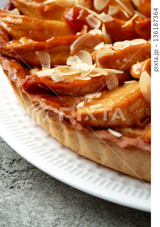 Dessert dish with baked apples and almond slices on white plate Dessert dish with baked apples and almond slices on white plate 136187364