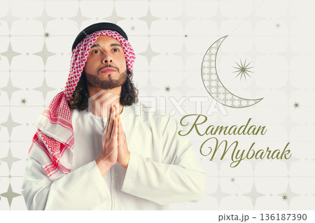 Muslim man prays during Ramadan celebration in a decorated setting at evening time 136187390