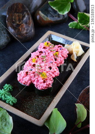 Baked rolls Volcano. Rolls with salmon and cocktail shrimp. Black tobiko caviar. Vertical photo on black background. 136188913