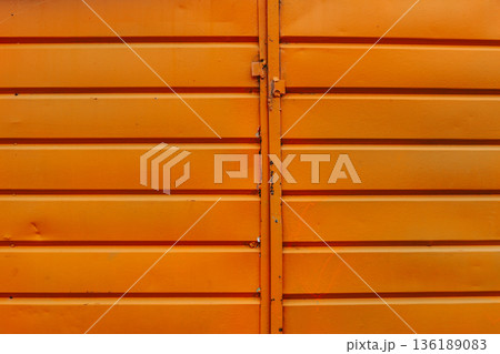 Cracked and rusty orange metal sheet texture close-up Cracked and rusty orange metal sheet texture close-up 136189083