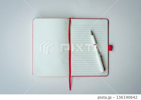 Open lined notebook with red bookmark and pen Open lined notebook with red bookmark and pen 136190642