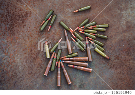Rifle Ammunition on Rusty Metal Background 136191940