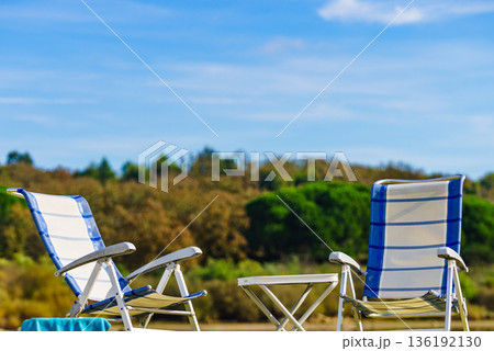 Two empty camp chairs on nature Two empty camp chairs on nature 136192130
