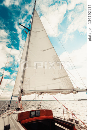 Yachting on sail boat during sunny weather Yachting on sail boat during sunny weather 136192152