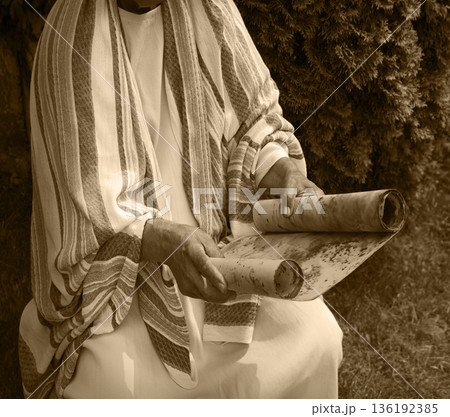 Old man reading the scroll 136192385