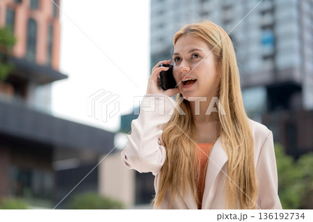Young caucasian businesswoman happy talk on smartphone outdoors. Young caucasian businesswoman happy talk on smartphone outdoors. 136192734