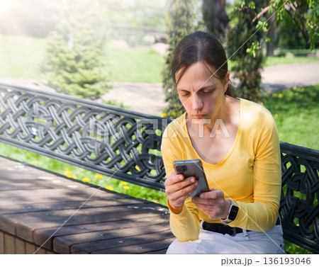 Young girl looking at phone Young girl looking at phone 136193046