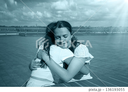 Two girls hugging in the cafe Two girls hugging in the cafe 136193055