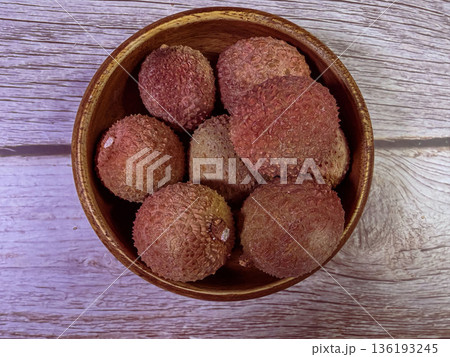 Fresh Whole Lychee Fruit in Wooden Bowl Overhead Rustic Tropical Still Life Fresh Whole Lychee Fruit in Wooden Bowl Overhead Rustic Tropical Still Life 136193245