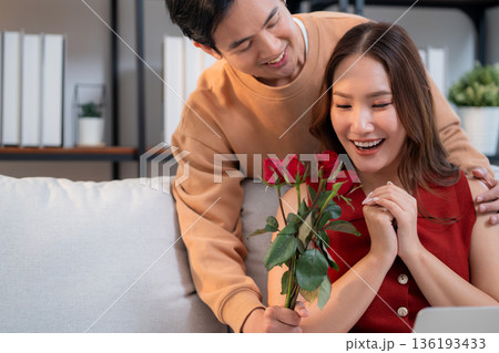 Happy asian woman receiving rose bouquet from boyfriend with celebrating Valentine's Day. 136193433