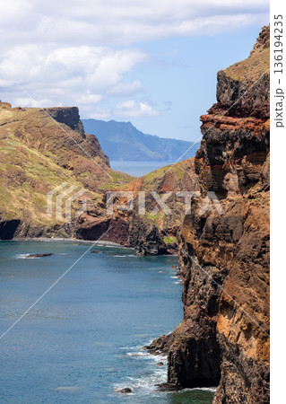 Vertical coastal landscape of Baia d Abra Point of Saint Lawrence with volcanic cliffs and sea Vertical coastal landscape of Baia d Abra Point of Saint Lawrence with volcanic cliffs and sea 136194235