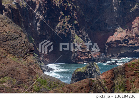 Volcanic coastal ravine at Ponta de Sao Lourenco Madeira with sheer basalt walls and cove sea Volcanic coastal ravine at Ponta de Sao Lourenco Madeira with sheer basalt walls and cove sea 136194236