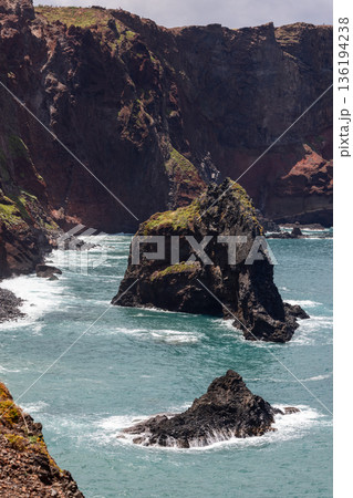 Vertical view of sea stacks beneath volcanic cliffs at Ponta de Sao Lourenco Madeira coast view Vertical view of sea stacks beneath volcanic cliffs at Ponta de Sao Lourenco Madeira coast view 136194238