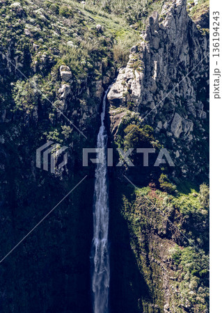Vertical view of Garganta Funda cascade cutting narrow chasm near Ponta do Pargo Madeira Portugal Vertical view of Garganta Funda cascade cutting narrow chasm near Ponta do Pargo Madeira Portugal 136194243