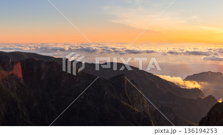 Sunrise over cloud sea and rugged mountain ridge at Pico do Arieiro Madeira Portugal dawn light 136194253