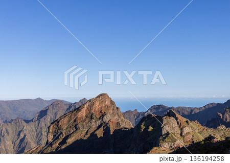PR1 hiking trail ridges on Madeira rise above Curral das Freiras and deep green valleys below 136194258
