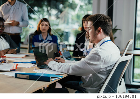Business people collaborating during busy corporate meeting Business people collaborating during busy corporate meeting 136194581