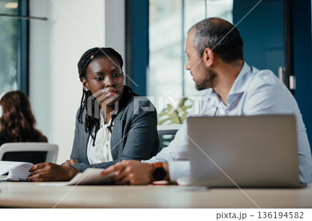Diverse business professionals discussing work in office meeting 136194582