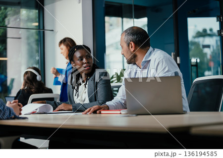 Business professionals collaborating in modern office meeting 136194585