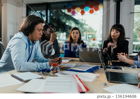 Business people collaborating during busy corporate meeting 136194606