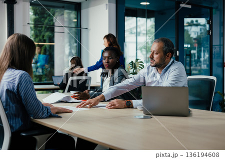 Diverse business team collaborating during an office meeting 136194608