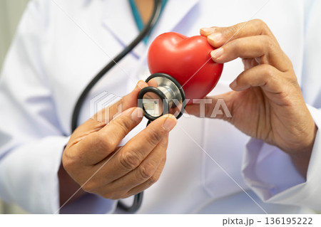 Asian woman doctor holding red heart for health in hospital. 136195222