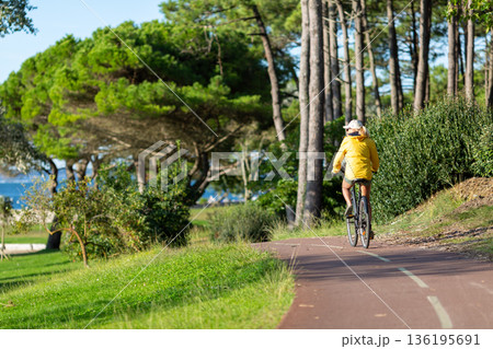 Person riding a bicycle on a cycle path Person riding a bicycle on a cycle path 136195691