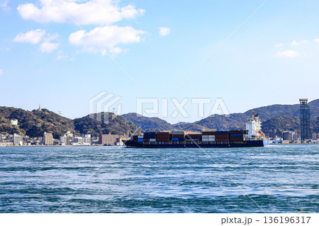A large ocean liner departed, toward the sea at Kitakyushu, Japan. 136196317