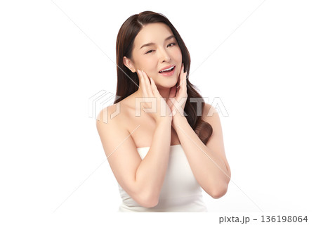 A beautiful young Asian woman with clean, fresh skin against a white background. Skincare, facial treatment, cosmetology, beauty, and spa. An elegant portrait of an Asian woman. 136198064