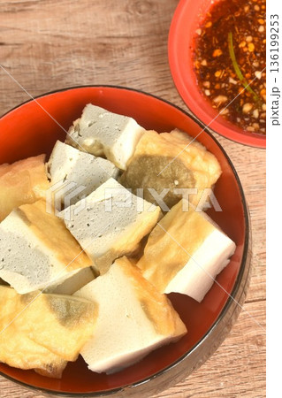 soft fried Japanese tofu dipping with sweet crushed bean sauce on bowl 136199253