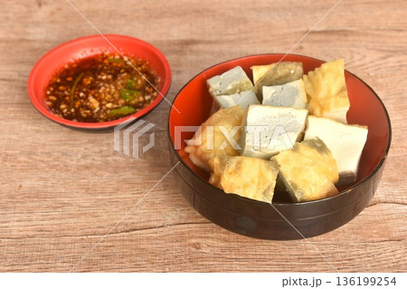 soft fried Japanese tofu dipping with sweet crushed bean sauce on bowl 136199254
