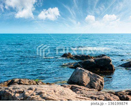 rocky shore of the sea coast under blue sky. beautiful view of coastal bulgaria on a sunny day. resort scenery near sozopol during vacation season in summer. place for vacation, retreats and escape 136199874