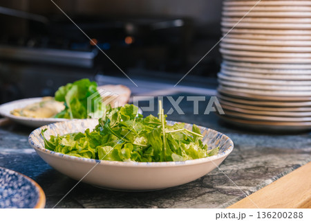 Fresh green salad in bowl on kitchen counter 136200288