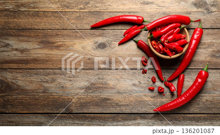 Ripe red chili peppers on wooden table, flat lay. Space for text Ripe red chili peppers on wooden table, flat lay. Space for text 136201087