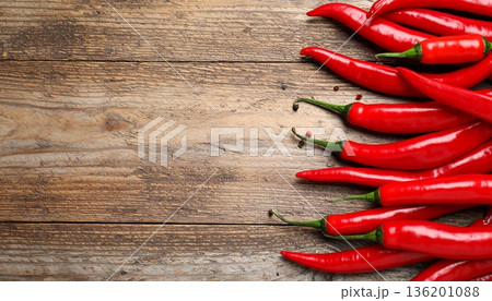 Ripe red chili peppers on wooden table, flat lay. Space for text Ripe red chili peppers on wooden table, flat lay. Space for text 136201088
