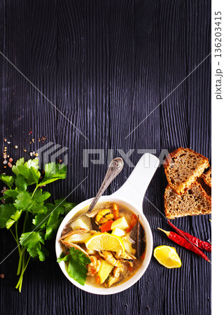 A popular dish of Asian cuisine - soup with shrimps Traditional spicy soup close-up 136203415