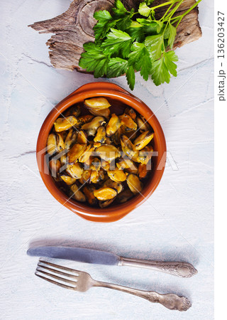 Mussels with sauce in a dish on a light background. 136203427