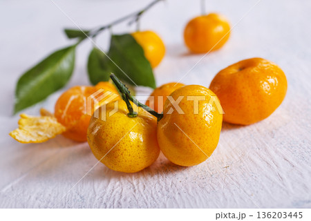Fresh juicy tangerines on light grey table Fresh juicy tangerines on light grey table 136203445