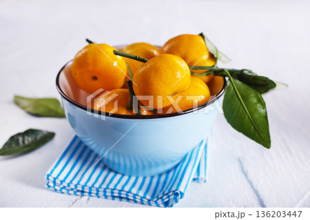 Fresh juicy tangerines on light grey table 136203447
