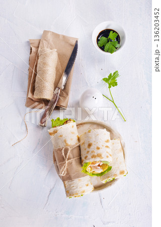 Burrito rolls with ham and cheese on a light background 136203452