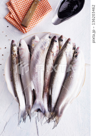 raw fish with spice on plate and on light table raw fish with spice on plate and on light table 136203462
