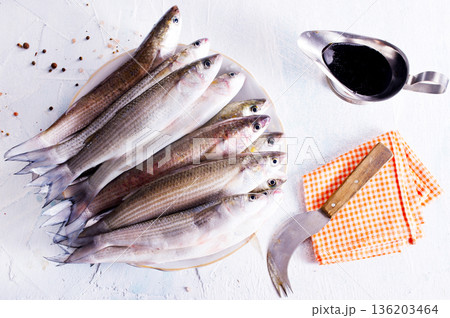 raw fish with spice on plate and on light table raw fish with spice on plate and on light table 136203464